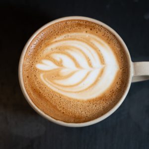 Top view of a cappuccino with latte art on a dark table in a Berlin café.